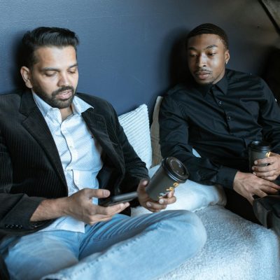 Man in Black Jacket Sitting Beside Man in Black Jacket